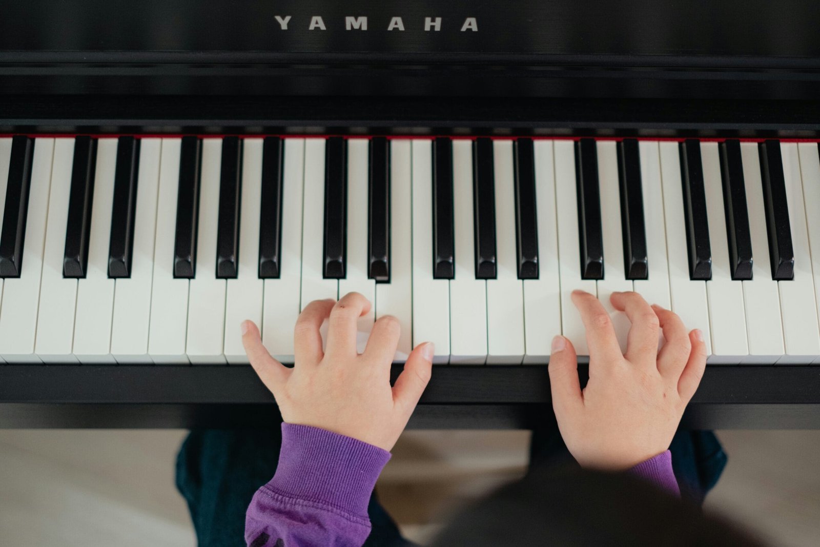 a person playing a piano with their hands